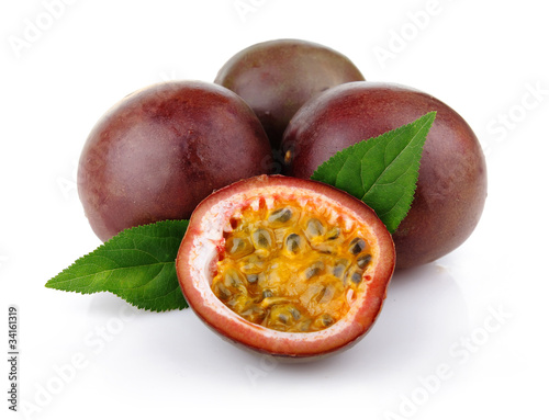 Fresh passion fruit with green leaves isolated photo