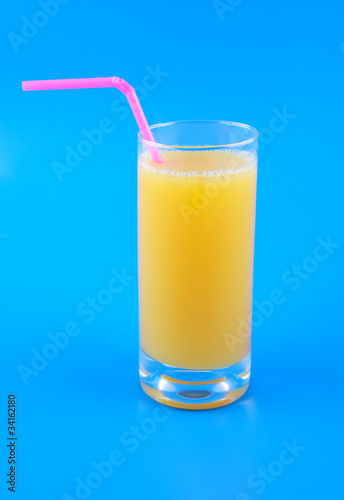 Orange juice in glass with straw