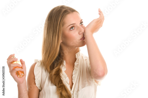 Woman smelling perfume on wrist