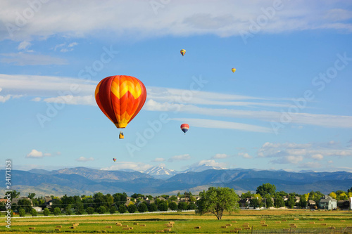 Hot air balloons flying over tranquil landscape