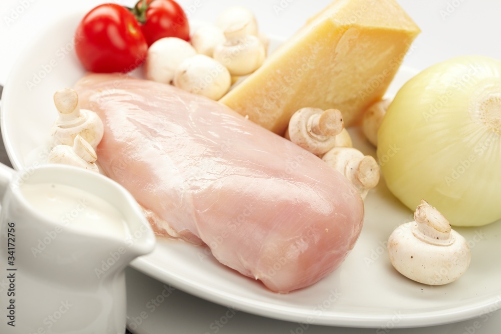 Fresh raw chicken fillets with vegetables Fresh raw chicken fillets with vegetables