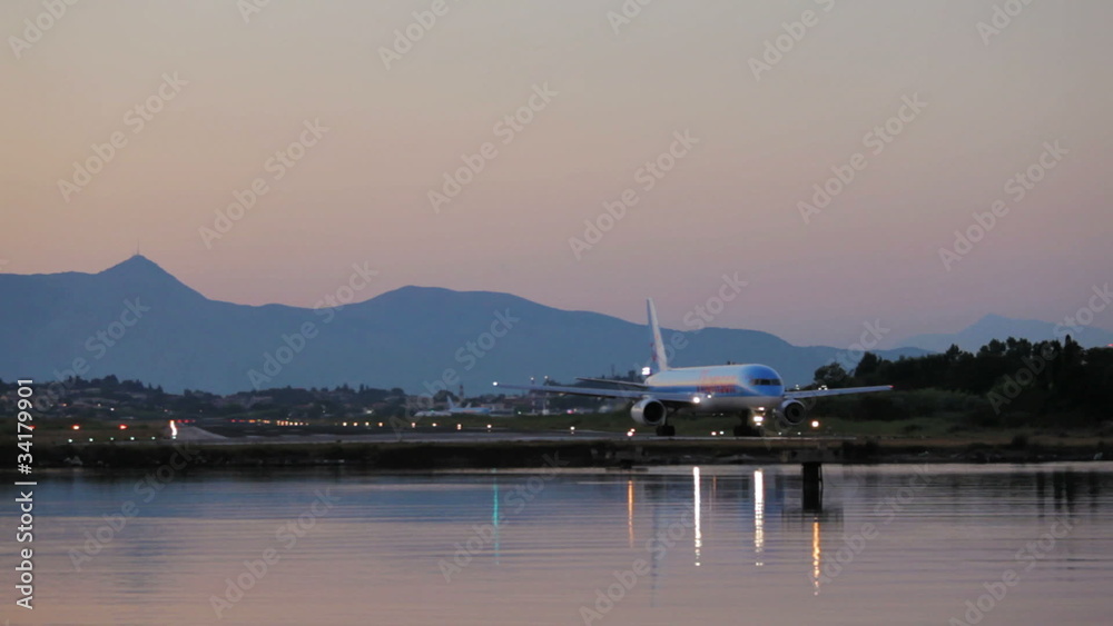 Driving of airplane before take-off, sunset scene, Corfu airport Driving of airplane before take-off, sunset scene, Corfu airport
