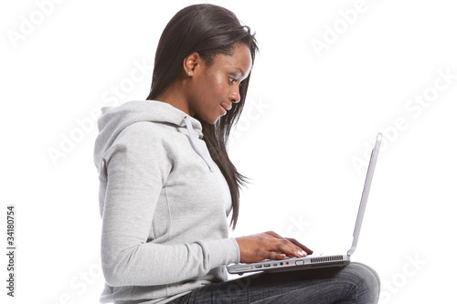 Young black girl sitting using computer laptop