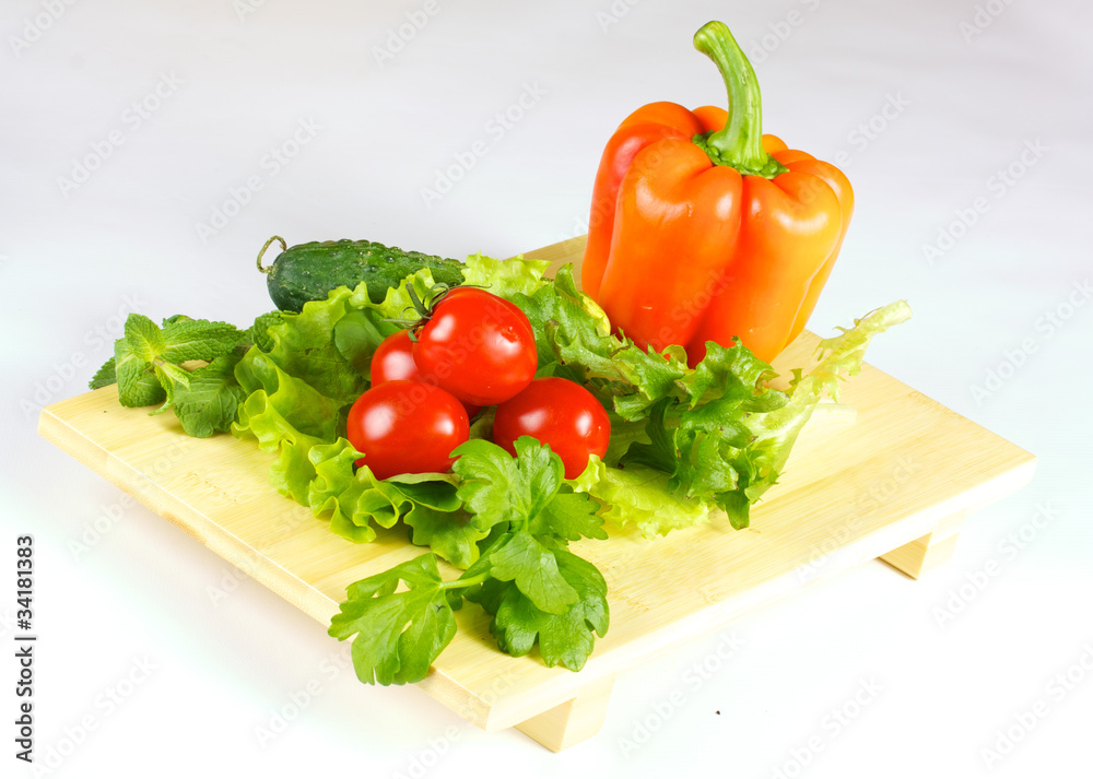 fresh and juicy vegetables on the wood plate isolated