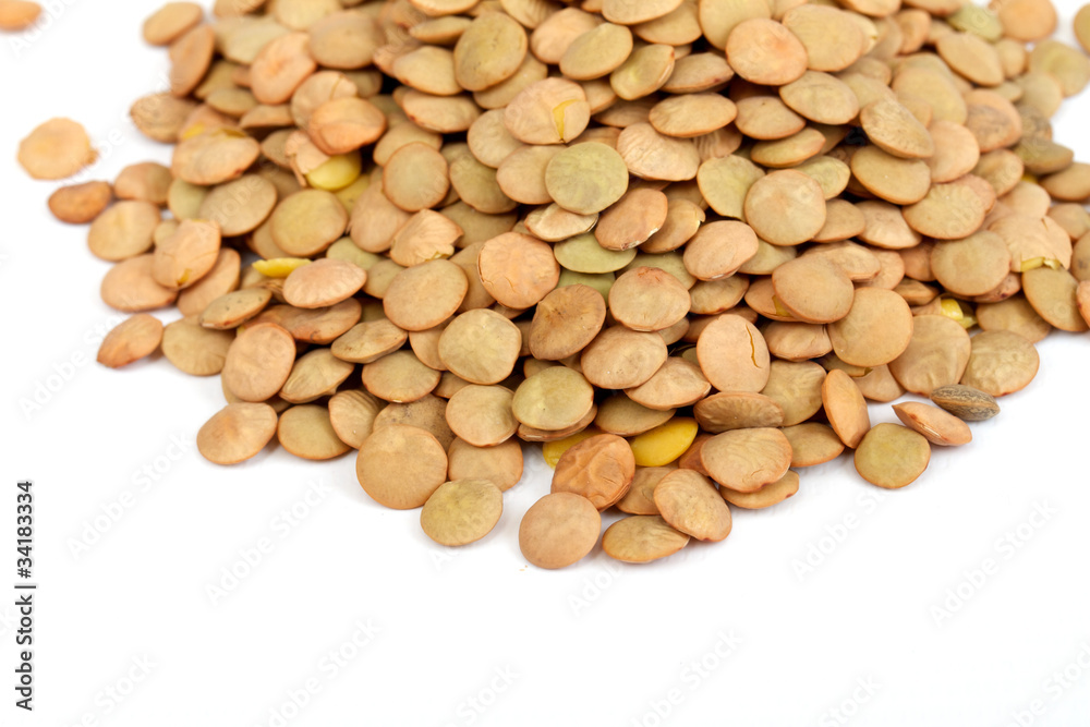 Pile of green lentils from low perspective isolated on white. Pile of green lentils from low perspective isolated on white.