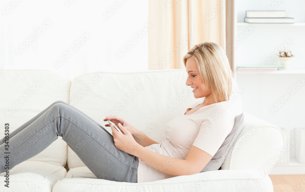 Blonde woman using a tablet computer Blonde woman using a tablet computer