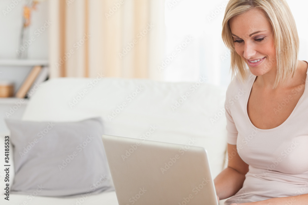 Close up of a smiling woman using a laptop Close up of a smiling woman using a laptop
