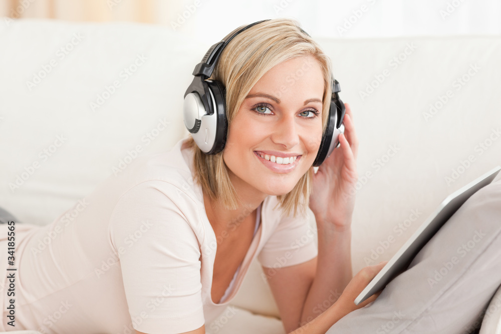 Naklejka premium Woman with a tablet computer and headphones