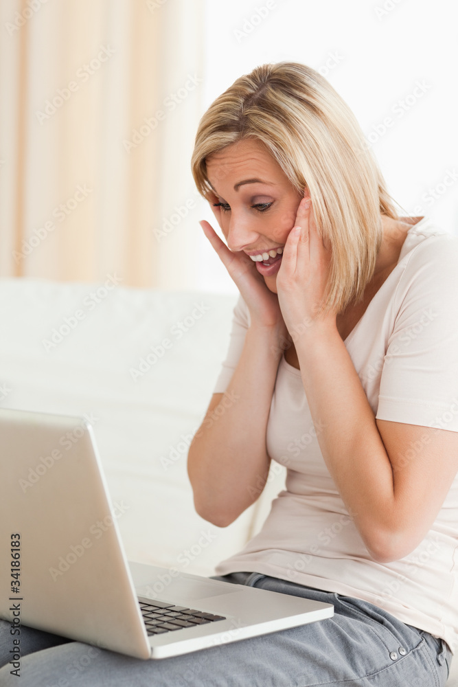 Delighted woman looking at a laptop Delighted woman looking at a laptop