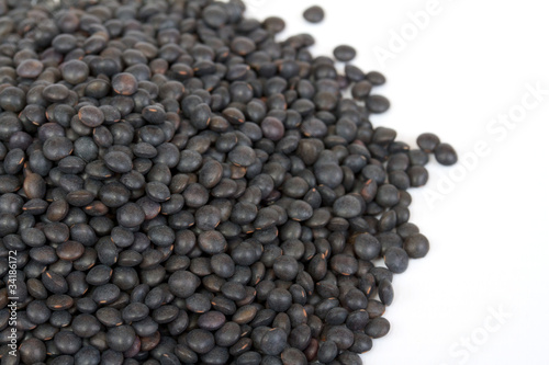 Heap of black lentil isolated on white © Andrei Starostin