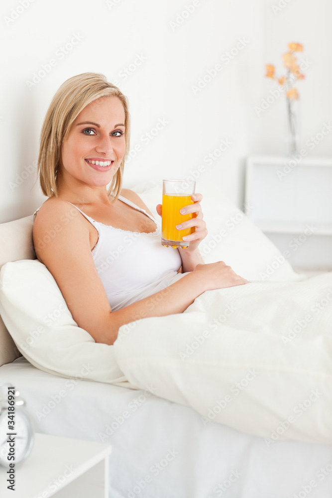 Portrait of a woman drinking orange juice Portrait of a woman drinking orange juice