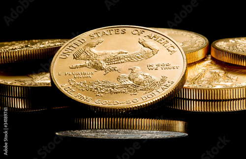Macro image of gold eagle coin on stack photo