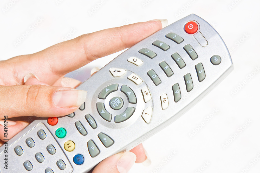 TV remote at woman's hand TV remote at woman's hand