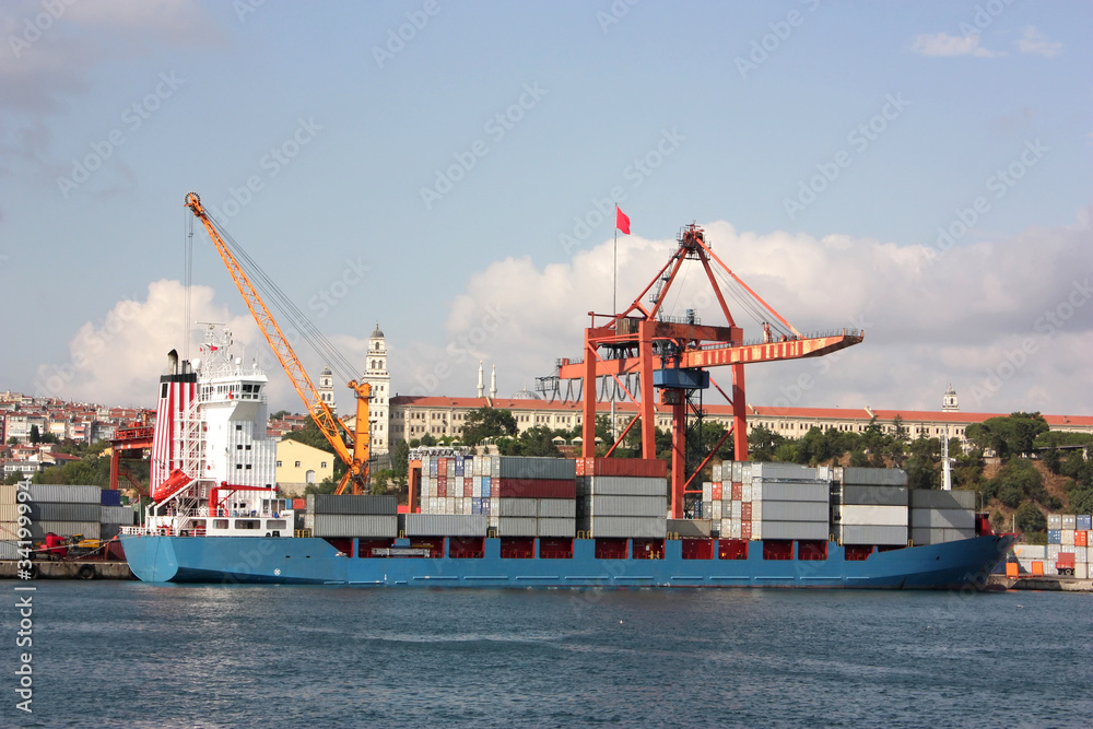 Large container ship in a dock at port - Side view Large container ship in a dock at port - Side view