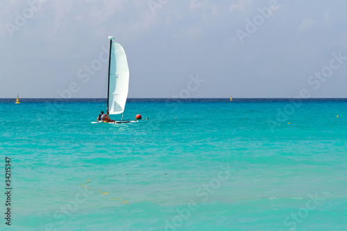 Catamaran with white sail  on the Caribbean sea