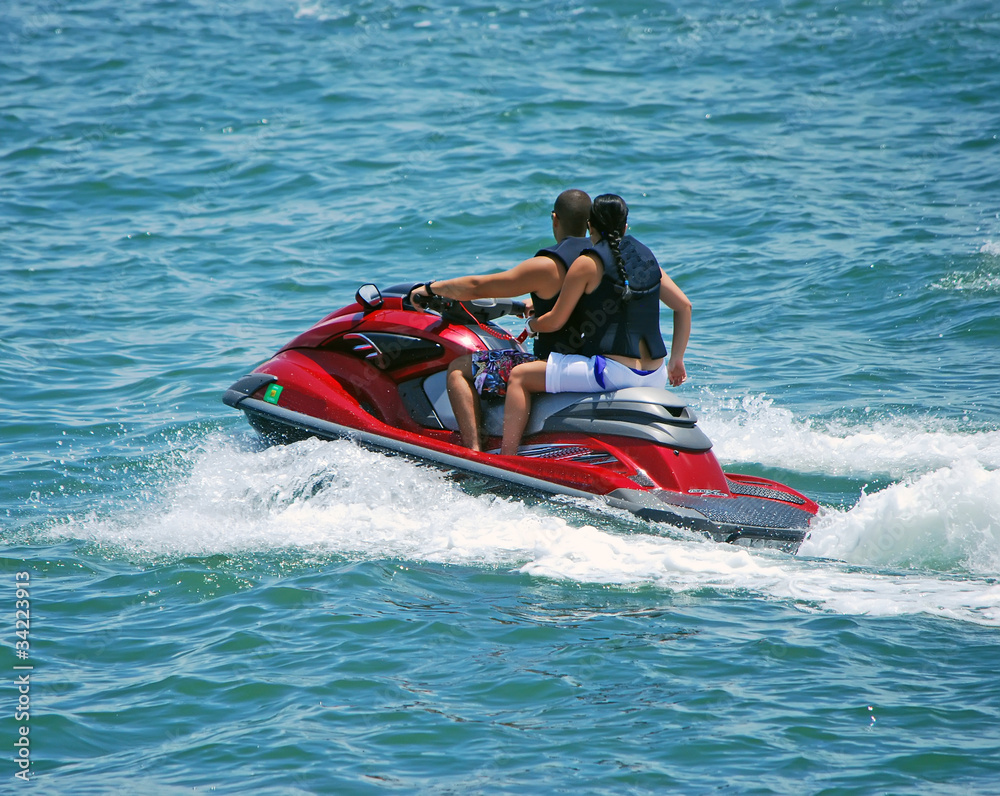 Boy and Girl and a Red Jetski