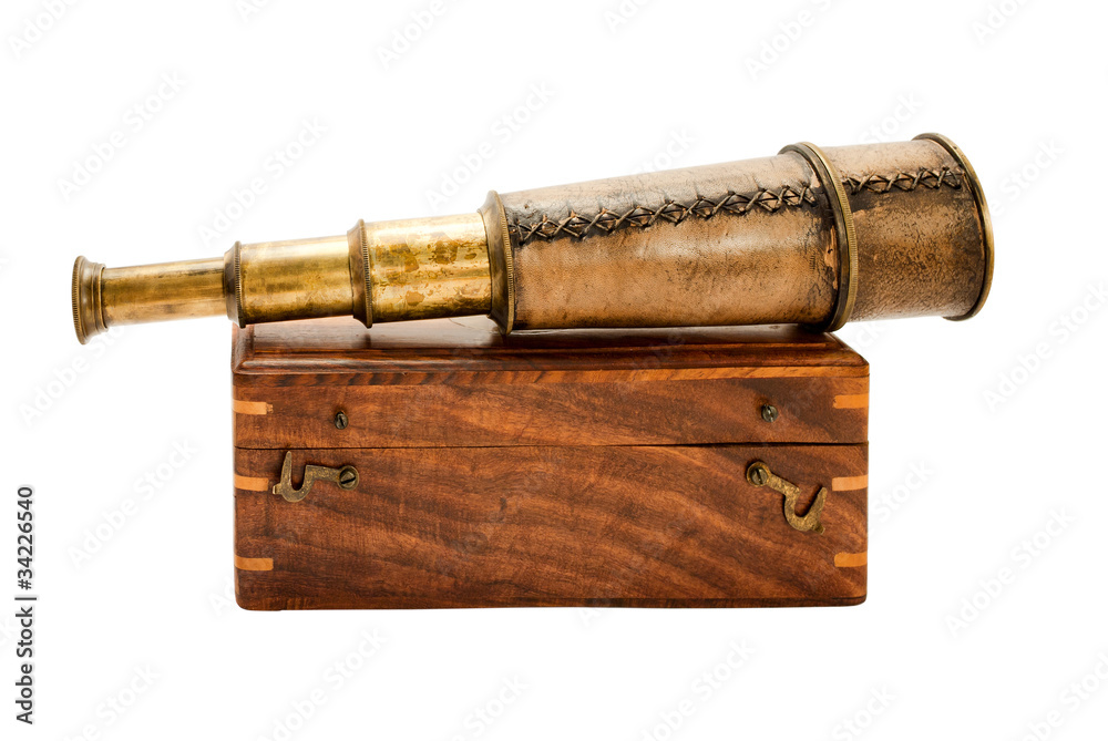 Antique spyglass and a wooden chest.