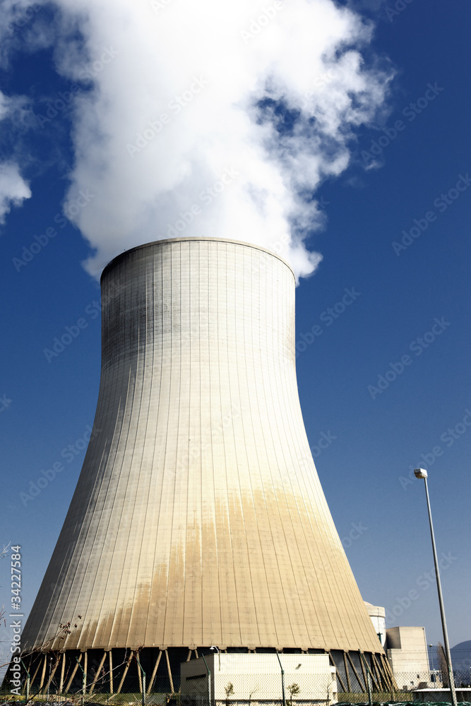 big smokestack of nuclear factory with blue sky