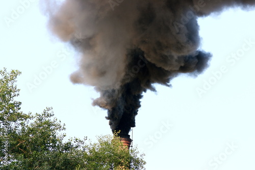Photography Smoking factory stack against a blue sky
