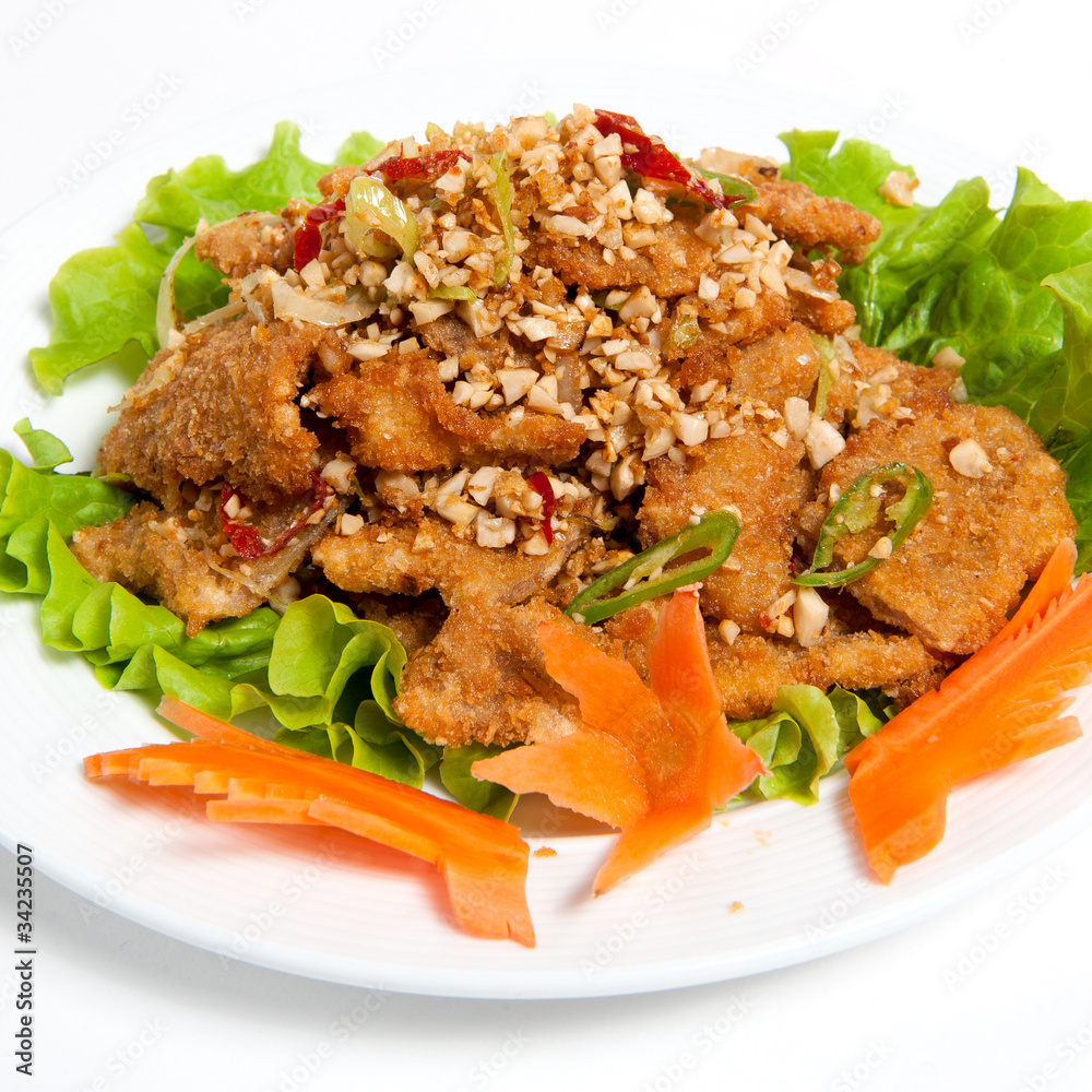 battered beef with peanut on a plate battered beef with peanut on a plate