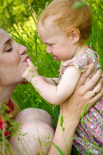 Portrait of mother and her little baby playing - outdoors