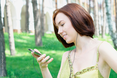 Girl listening to music outdoors