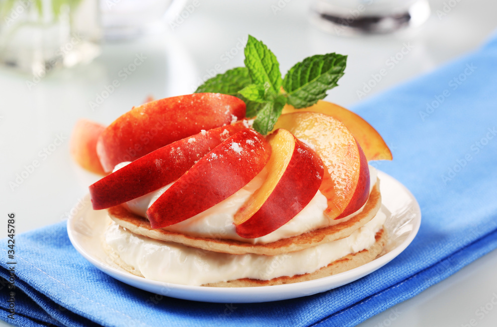 Pancakes with sweet cheese and fresh nectarine