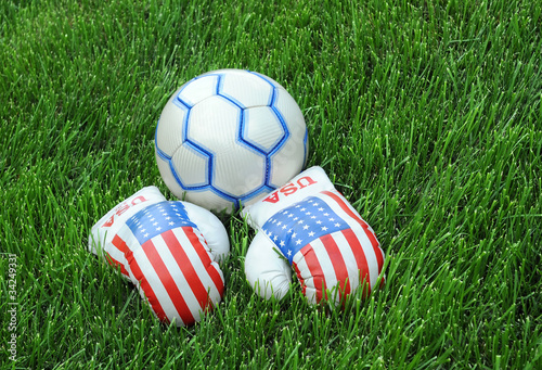 Boxing Gloves and Soccer Ball on Green Lawn