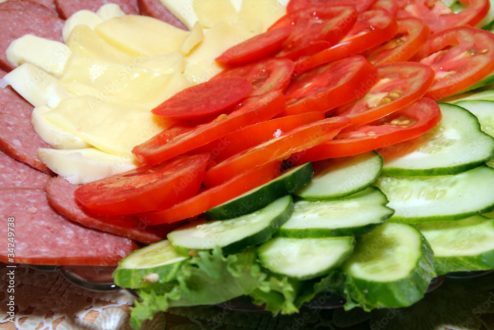 Plate with threaded cucumbers, tomatoes, cheese, sausage Plate with threaded cucumbers, tomatoes, cheese, sausage