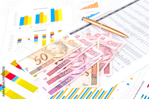 financial chart and datasheet. Brazilian money and pen.