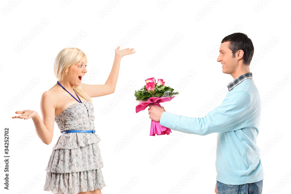 Boyfriend giving flowers to his surprised girlfriend Boyfriend giving flowers to his surprised girlfriend