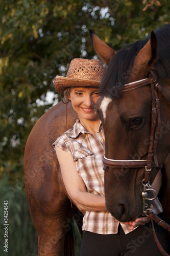 Young woman hold horses head © PaulShlykov