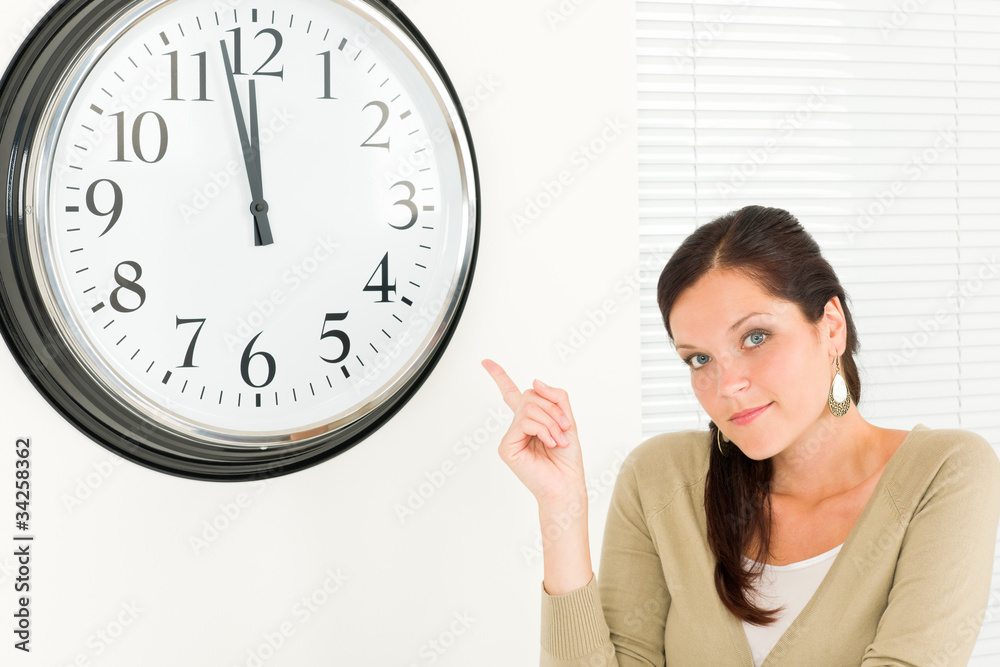 Punctual businesswoman attractive point at clock Punctual businesswoman attractive point at clock