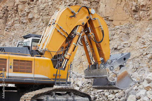 Excavator loading the crushed stone in quarry