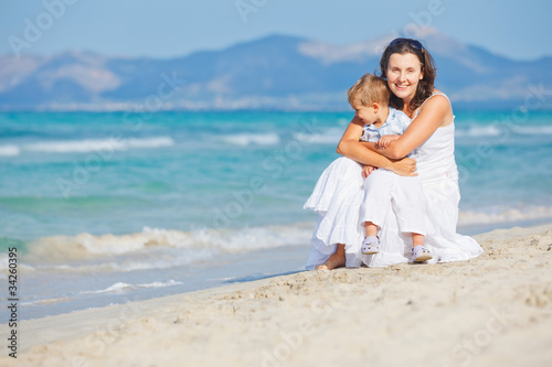 Young mother with her son on beach vacation