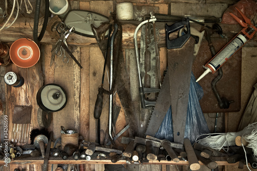 different old tools hanging on a barn wall