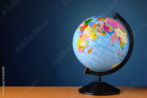 globe on a table against the wall of blue