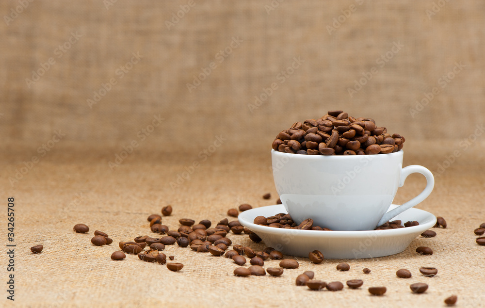 White cup with coffee grains White cup with coffee grains