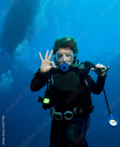 Woman scuba diver under boat #34277108