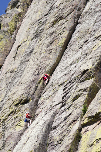 Climbers hanging from the wall.