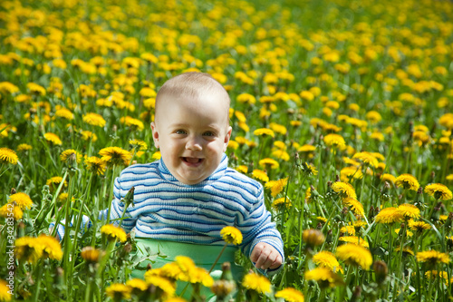 happy baby  in flowers meadow