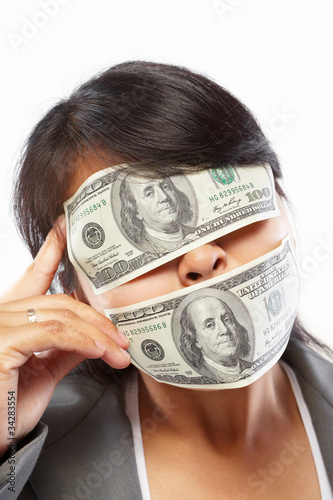 Businesswoman being blinded with money