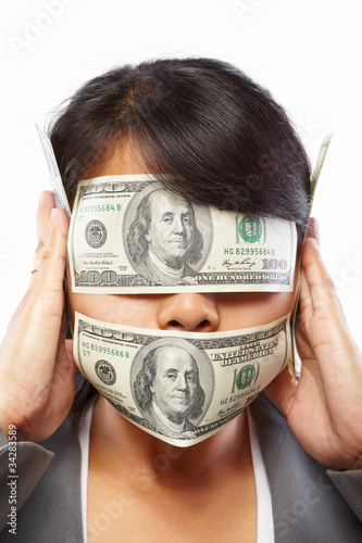 Businesswoman being blinded with money