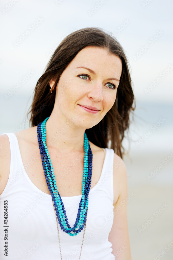 Portrait of a beautiful brunette woman with a necklace