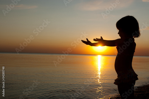Child on sunset beach