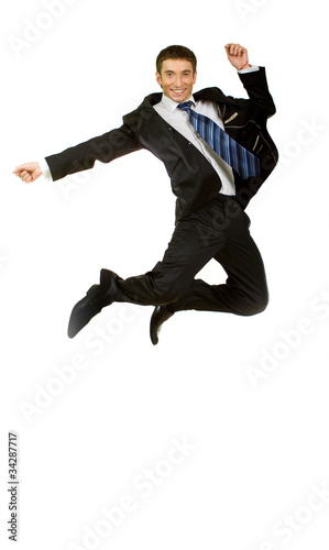 Happy businessman jumping in air against isolated white