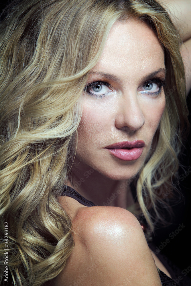 Attractive blond woman with long curly hair. Attractive blond woman with long curly hair.