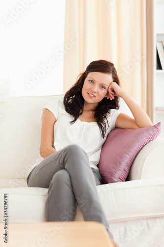 Portrait of a cute posing woman on a sofa