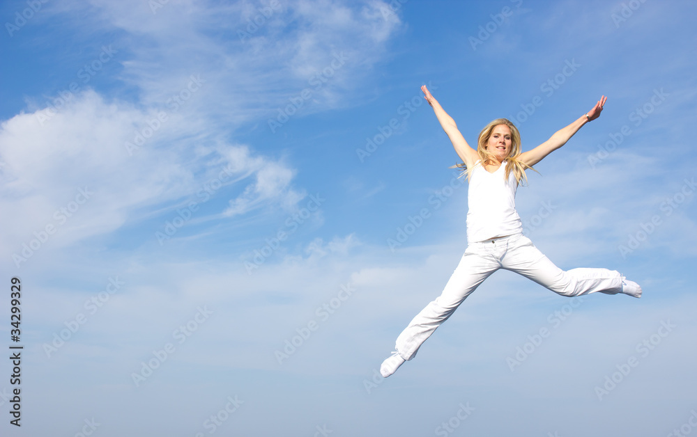 Beautiful blond girl flying in the air, concept of freedom