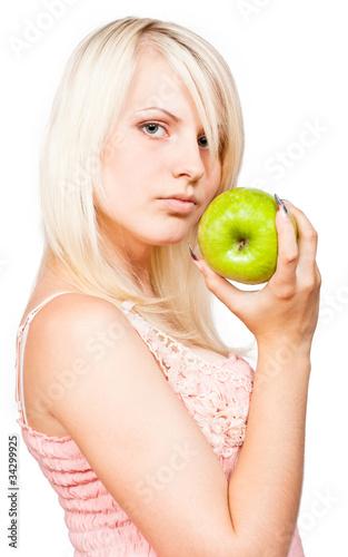 Beautiful blonde girl with fresh green apple